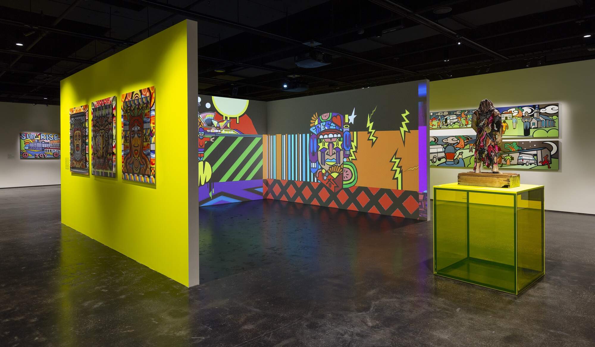 Photo of art gallery with artworks hanging on a neon yellow wall, projections of paintings on another set of walls, and a ceramic artwork on a yellow rectangular plinth